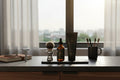 Organized modern men's vanity with natural sunlight illuminating Duke Cannon beard oil bottle and wash tube