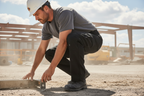 Dickies Flex Cargo Pant black 40x32 worn by man in active crouching pose demonstrating flex fabric movement – More4less Outlet