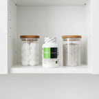 DaVinci Laboratories NAC 500mg bottle in minimalist bathroom cabinet shelf with apothecary glass jars