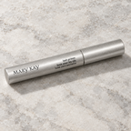 Mary Kay Lash Primer silver tube on a pale neutral stone surface