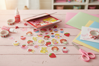 Strawberry Shortcake scratch and sniff sticker pad on pink craft table with scrapbooking supplies and classic retro character stickers