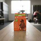 Closed KT Tape Pro Winner Green package on a gym bench in a softly blurred gym