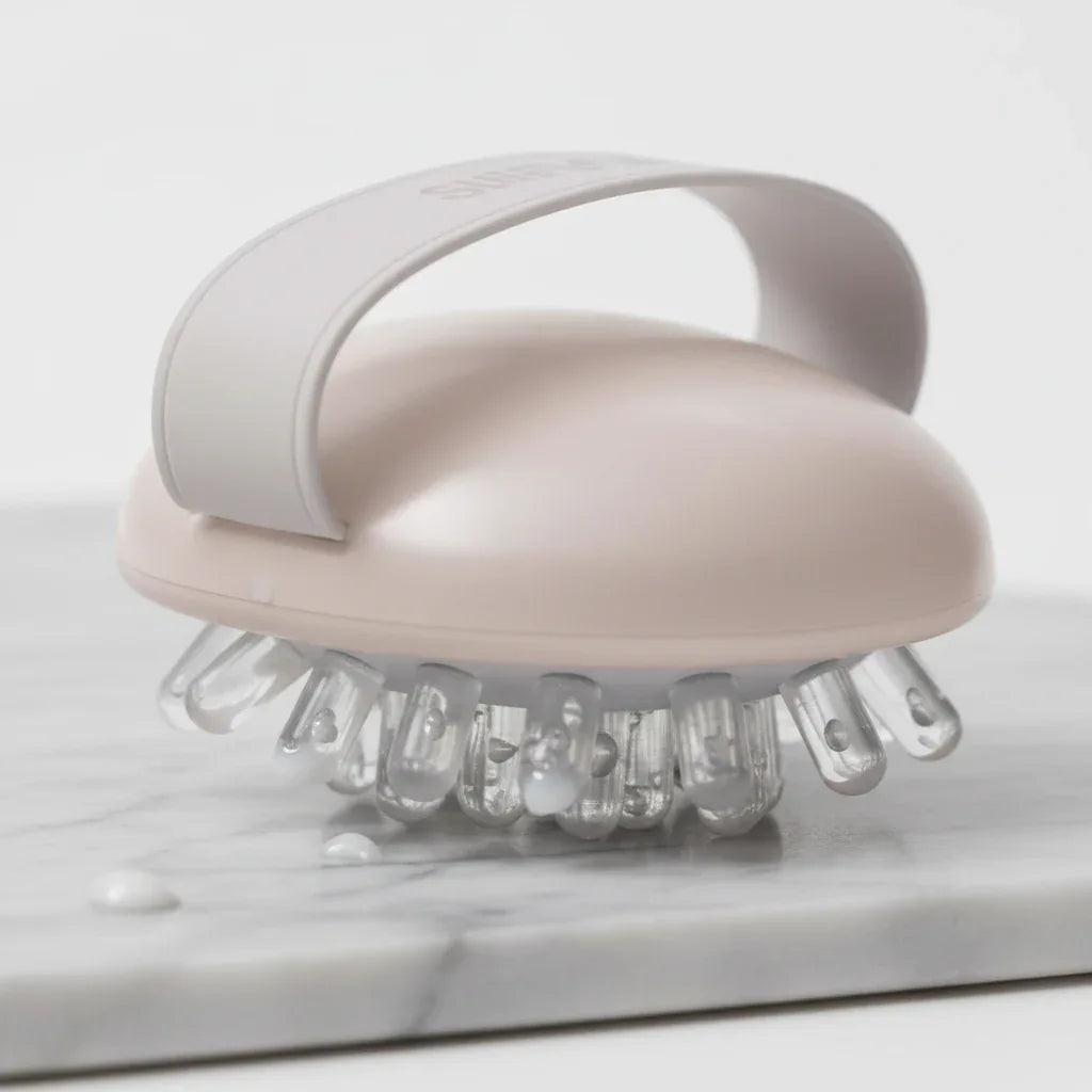 Detail-focused imagery of skin wellness massage tool with nodule tips for effective body cream application and contouring