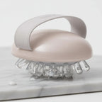 Detail-focused imagery of skin wellness massage tool with nodule tips for effective body cream application and contouring