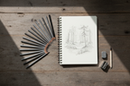 12 graphite pencils and mixed media notebook art supply flat lay — More4less Outlet