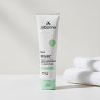 Arbonne Instant Cooling Moisture Mask with Peppermint 5 oz tube in a minimal skincare setting beside folded towels