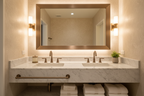 High-end bathroom vanity with bronze hardware fixtures and warm ambient lighting