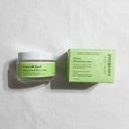 Overhead flat lay of Cocokind Texture Smoothing Cream jar and green box on white linen surface, bright even lighting
