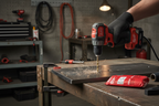 Tradesperson using Milwaukee Thunderbolt drill bit to drill through steel plate in professional workshop - More4less Outlet