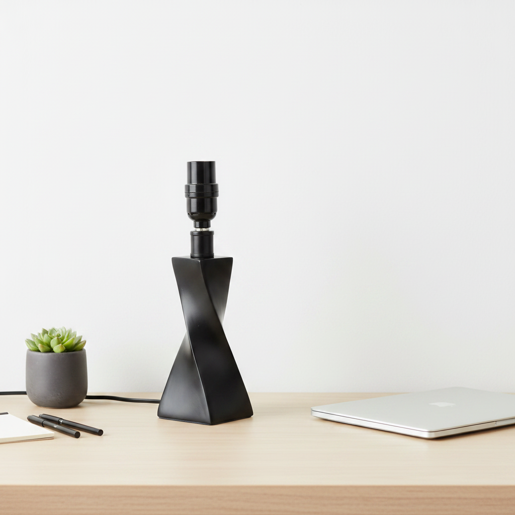 Modern desk display with matte black twisted lamp base against clean neutral tones and light wood surface