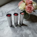 Mary Kay True Dimensions lipstick tubes on marble vanity with roses