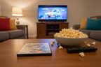 The SpongeBob Movie Sponge Out of Water DVD on living room coffee table with popcorn and TV remote family movie night – More4less Outlet