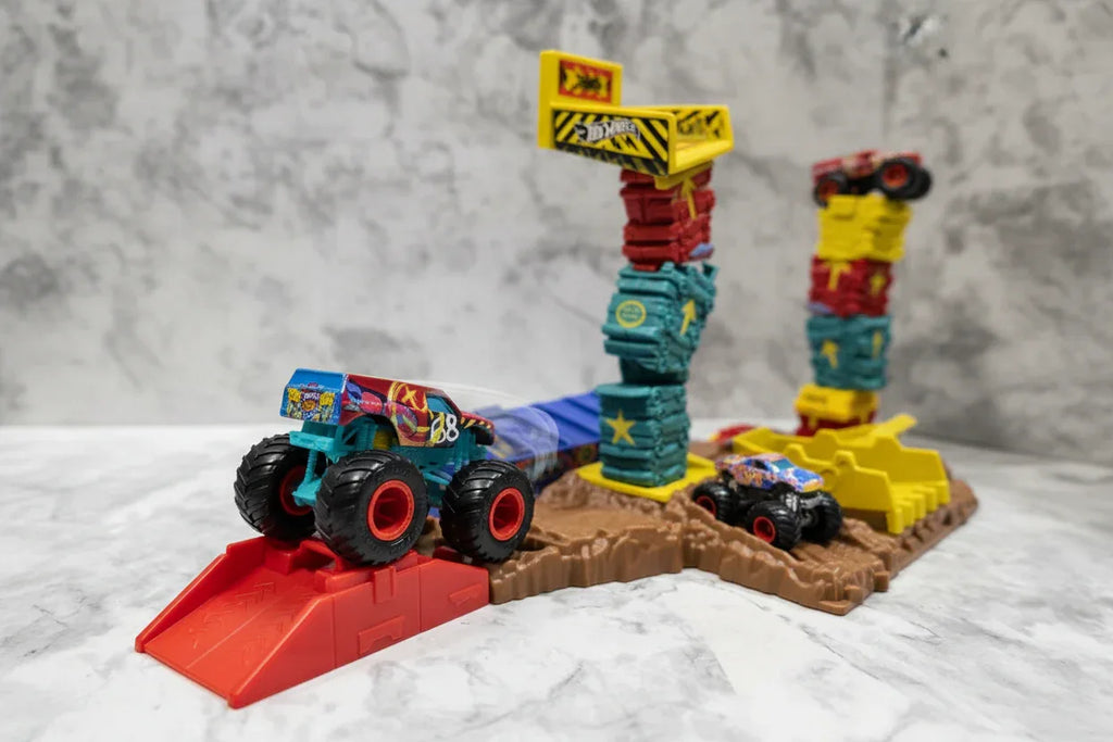 Close-up action play scenario with monster truck on launcher ramp
