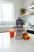 Bright lifestyle setting featuring a large dietary supplement drink bottle on a clean white kitchen counter