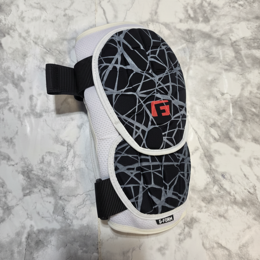 AI-generated contextual image of a G-Form Elite 2 baseball batter's elbow guard shown flat with adjustable straps