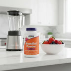 NOW Foods Inositol Powder 8oz bottle on white quartz kitchen island next to high-speed blender and bowl of fresh berries