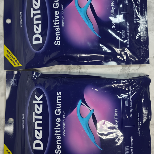 Close view of two sealed DenTek Sensitive Gums Comfort Clean floss pick bags