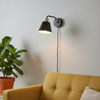 Globe Electric Lex matte black brass wall sconce in mid-century modern living room