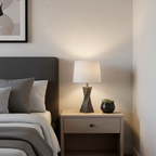 Apartment bedroom nightstand with compact stone gray twisted lamp base in modern minimal decor