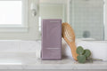 KEVIN.MURPHY HYDRATE-ME.WASH on marble bathroom shelf with brush and towel lifestyle