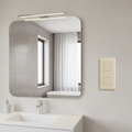 Clean modern bathroom wall with light almond triple rocker switch mounted beside mirror