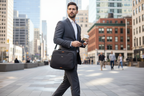 Solo New York Ace Slim Brief grey worn over shoulder by professional commuter in city — slim laptop briefcase — More4less Outlet