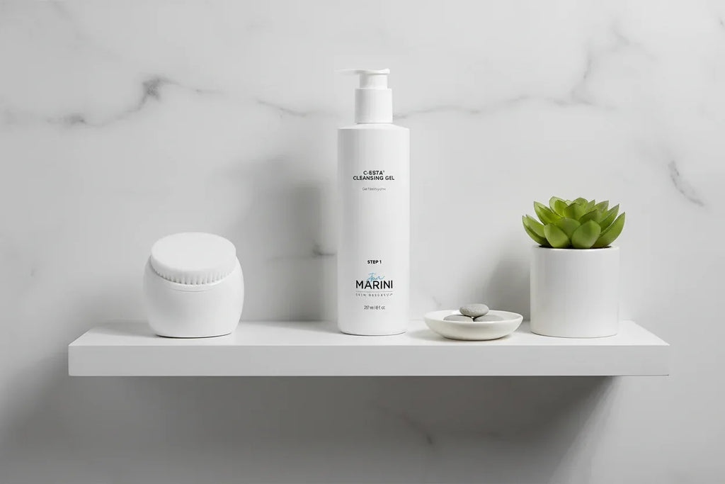 Jan Marini C-ESTA Cleansing Gel on bathroom shelf with face brush and plant lifestyle