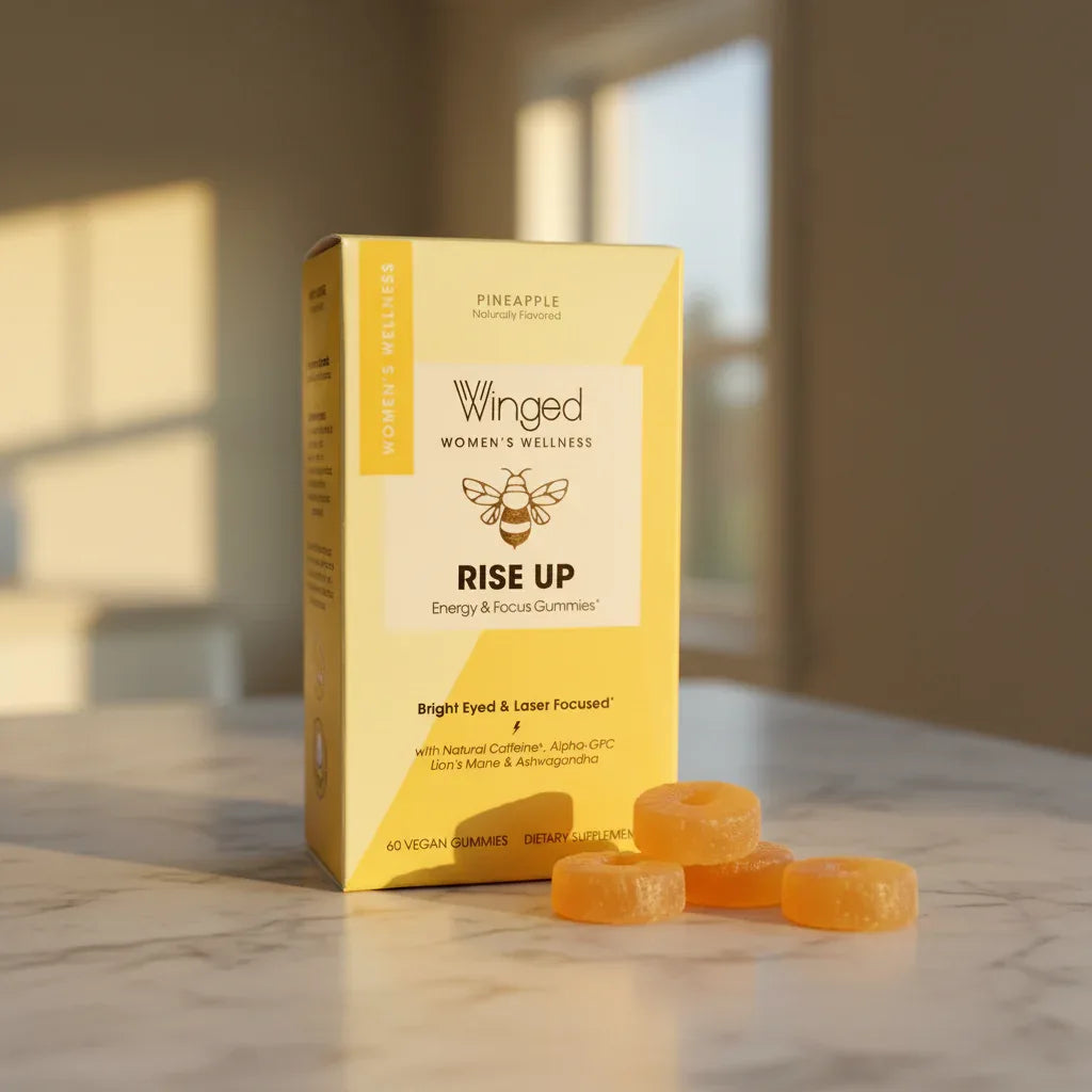 Winged Rise Up gummies yellow box on marble countertop with pineapple gummies lifestyle image