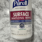 Macro close-up of Purell Foodservice Surface Sanitizing Wipes label highlighting Surface Sanitizing Wipes Fragrance Free and Eliminates Listeria E Coli and Norovirus