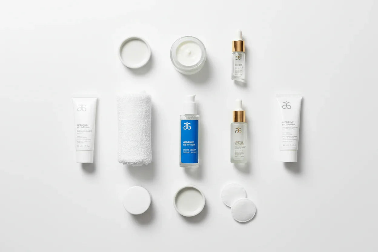 Arbonne Bio-Hydria Liquid Serum skincare flat lay on white surface with rolled towel