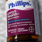 Close-up of the Phillips' Colon Health Daily Probiotic label showing 4-in-1 Symptom Defense details