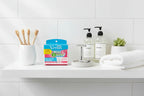 Organized shelf of personal care essentials including razor cartridges in a bright minimalist spa bathroom setting