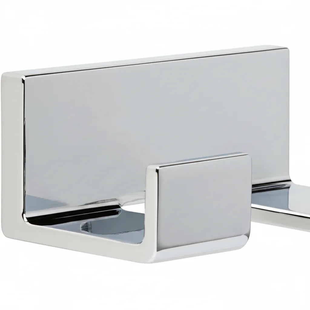 Studio macro of polished chrome double hook bathroom hardware showing geometric profile