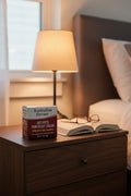 Australian Dream Arthritis Pain Relief Cream on dark walnut nightstand with bedside lamp and open book — More4less Outlet