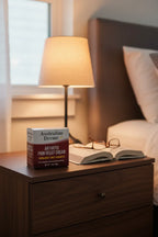 Australian Dream Arthritis Pain Relief Cream on dark walnut nightstand with bedside lamp and open book — More4less Outlet
