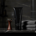 Lifestyle context image of Mary Kay Cityscape Hair and Body Wash (AI-generated for visual illustration only) – dark marble bathroom shelf with grooming accessories – More4less Outlet