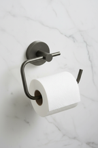 Grohe Essentials Hard Graphite toilet paper holder with toilet paper roll mounted on white marble bathroom wall