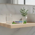 Nature's Answer PerioBrite Coolmint Toothpaste 3-Pack on modern light-wood floating bathroom shelf with water tumbler and eucalyptus plant