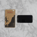Overhead flat lay of rugged phone case retail packaging next to Samsung Galaxy S8 showing size compatibility
