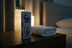 Serene evening bedside table setup with Will Perform REST nightly body lotion next to a folded towel