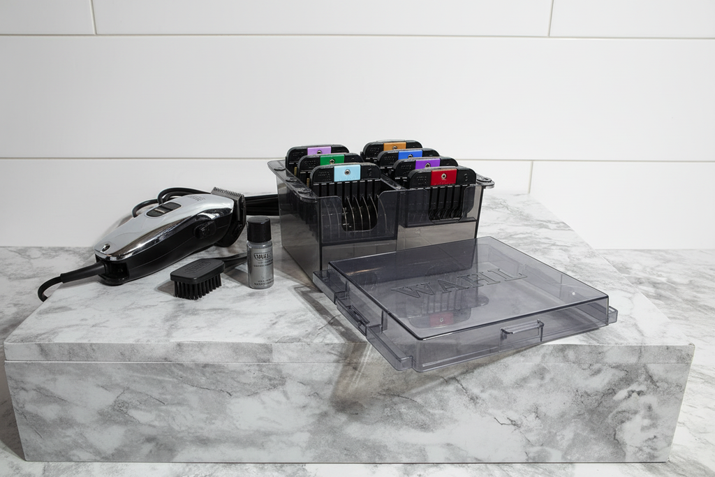 Wahl 8-piece color-coded clipper guide comb set in storage case on barbershop counter with Wahl clipper – More4less Outlet