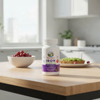 Mary Ruth's Iron Gummies bottle on wooden breakfast nook in morning sunlight lifestyle image