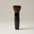 Mary Kay Mineral Foundation Brush standing on a neutral studio surface