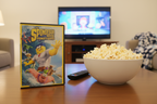 The SpongeBob Movie Sponge Out of Water DVD on living room coffee table with popcorn and TV remote family movie night – More4less Outlet