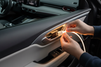 Person installing LED flex strip lights inside car door panel with quick-clip connector and ambient glow