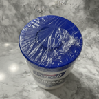 Close-up of outer shrink-wrap seal on Purell Professional Wipes canister demonstrating moisture-retention packaging