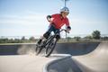 G-Form Youth Pro-X2 Elbow Pads worn by young kid riding BMX bike at skate park