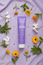 Pacifica Vegan Ceramide Face Wash flat lay on lavender background with marshmallow root and calendula flowers