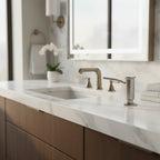 Modern bathroom vanity with Kohler brushed stainless soap dispenser mounted on white marble countertop