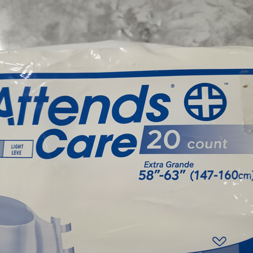Macro close-up of size chart on Attends Care Briefs Extra Large packaging highlighting 58-63 inch waist and 20 count
